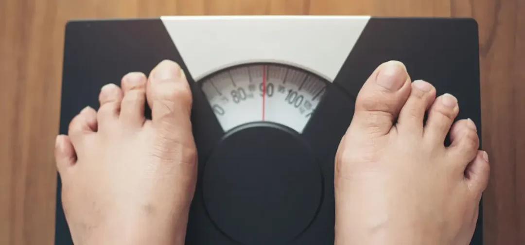 woman feet standing weight scale wooden